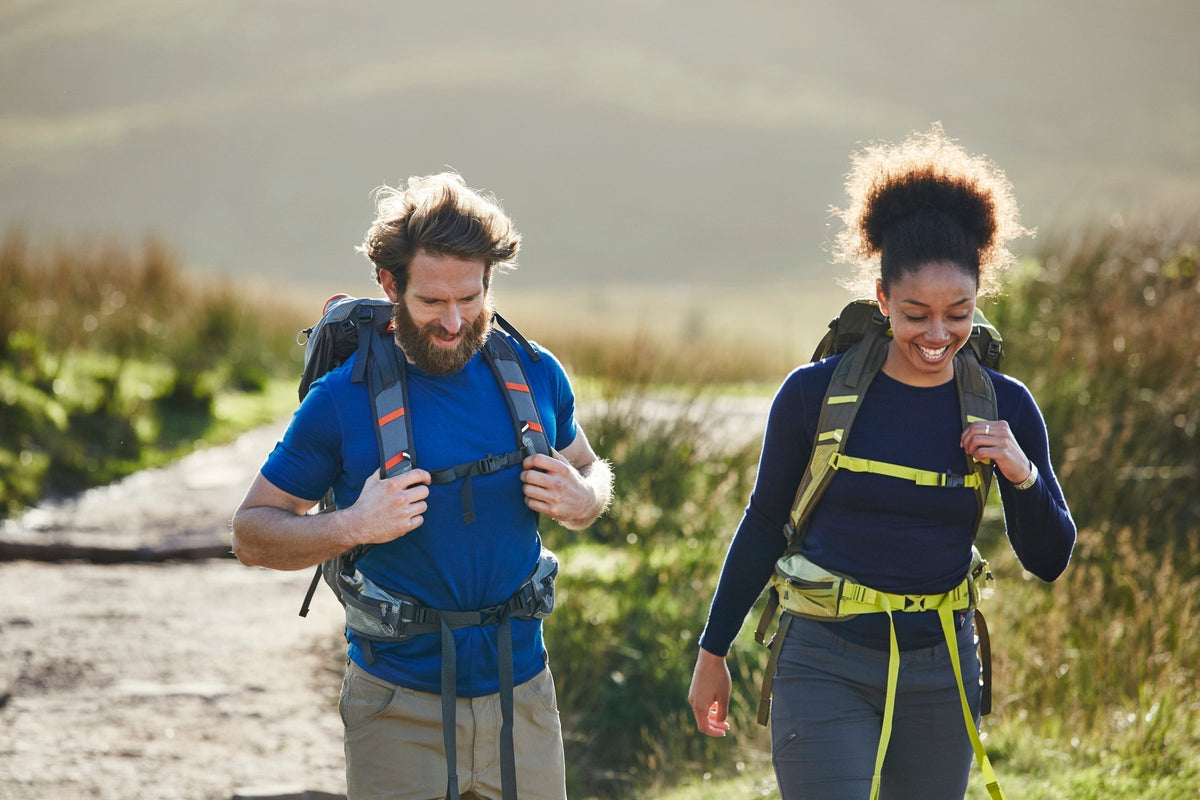 Two hikers walking on a dirt trail