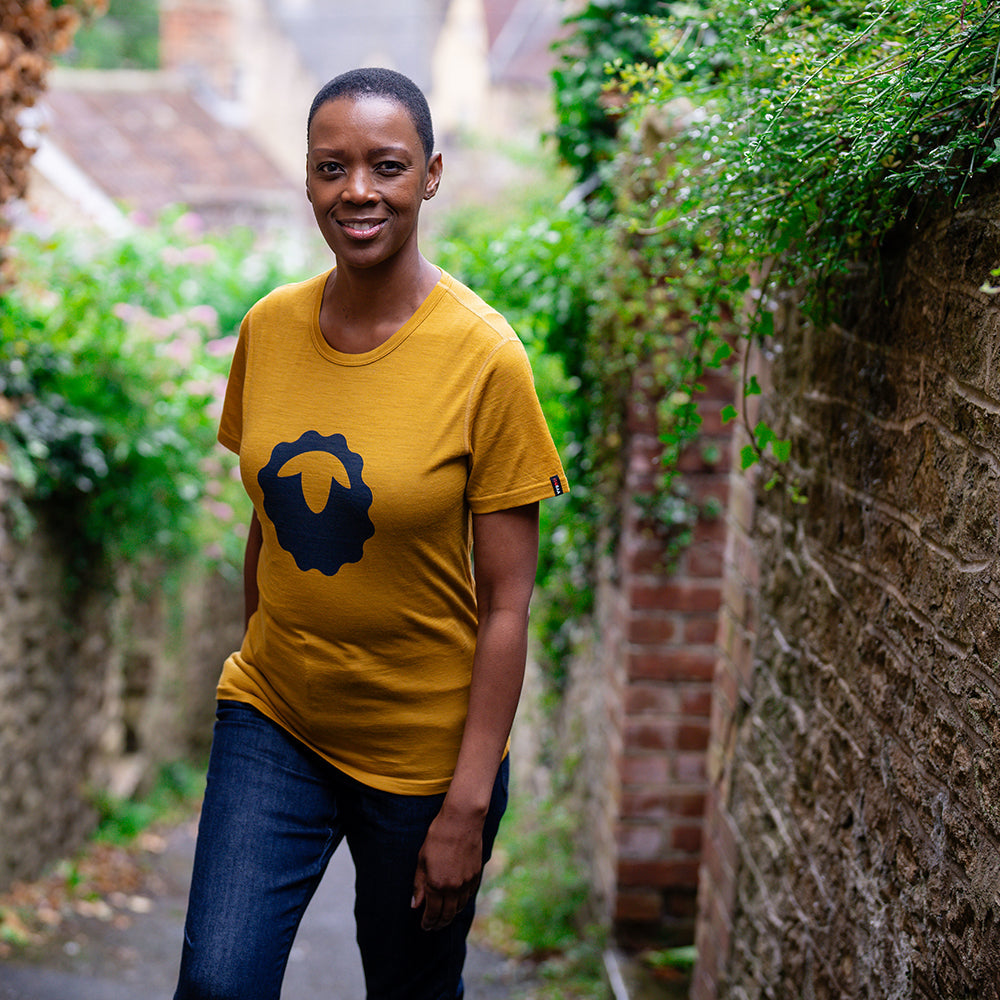 Isobaa | Womens Merino 150 Emblem Tee (Mustard/Navy) | Conquer trails and city streets in comfort with Isobaa's superfine Merino T-Shirt. | Model: Yolisa