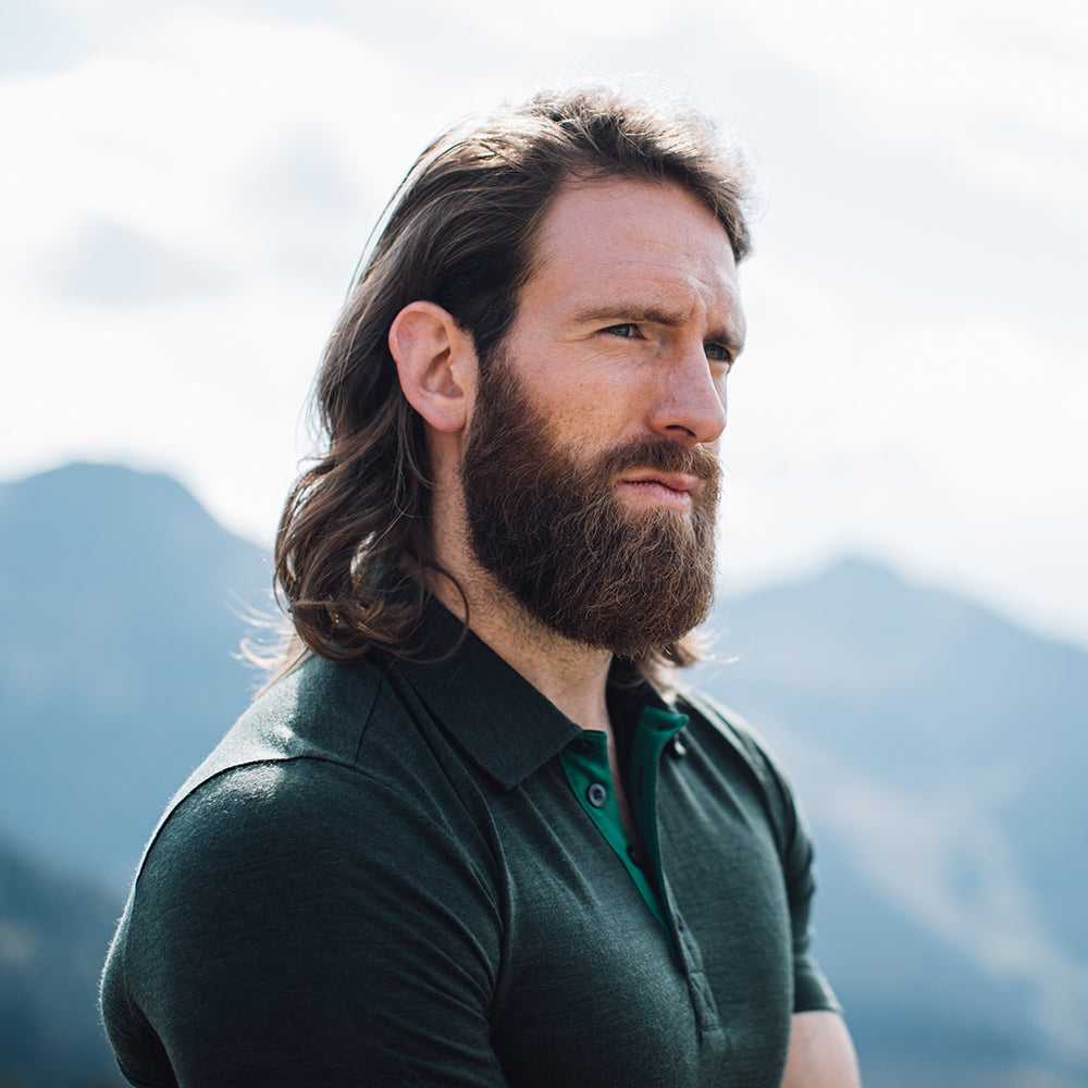 Isobaa | Mens Merino 180 Short Sleeve Polo Shirt (Black) | The ultimate Merino wool polo — perfect for weekend hikes, bike commutes, post-adventure coffee stops, office days, and everything in-between. | Model: Craig
