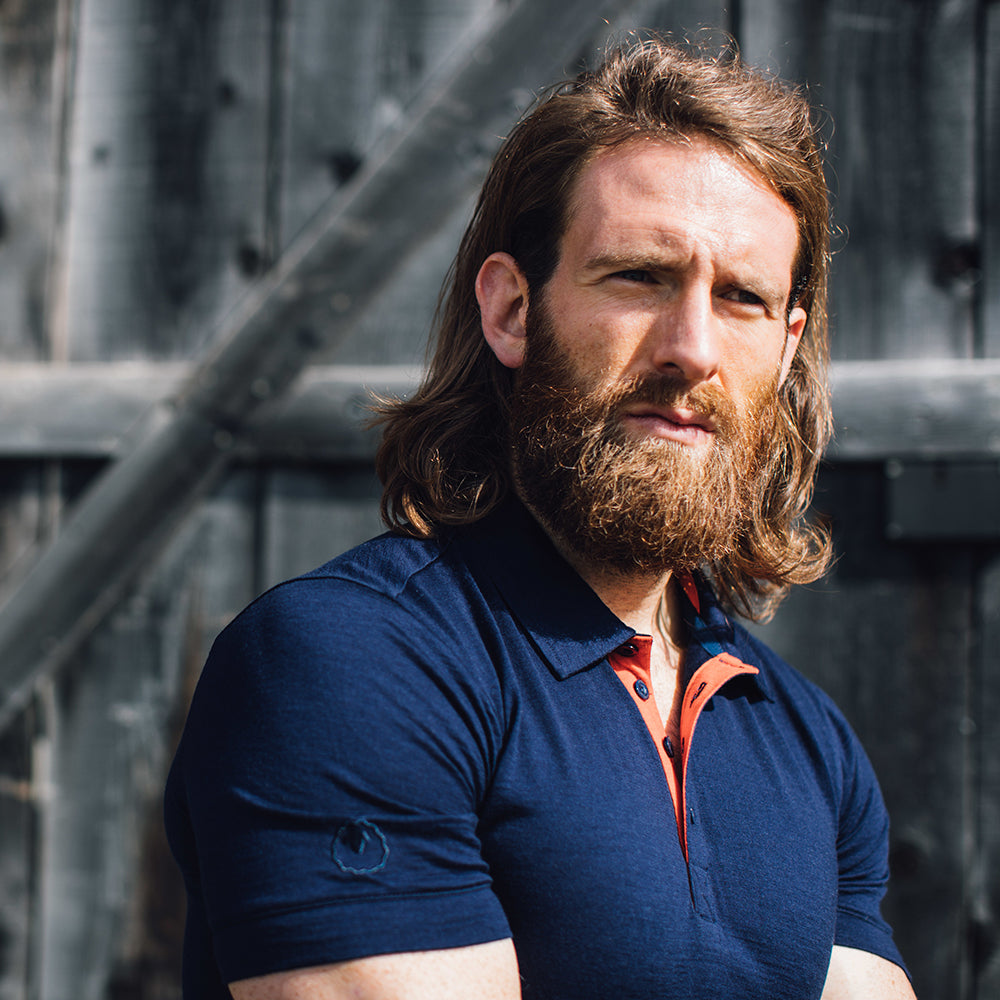 Isobaa | Mens Merino 180 Short Sleeve Polo Shirt (Black) | The ultimate Merino wool polo — perfect for weekend hikes, bike commutes, post-adventure coffee stops, office days, and everything in-between. | Model: Craig