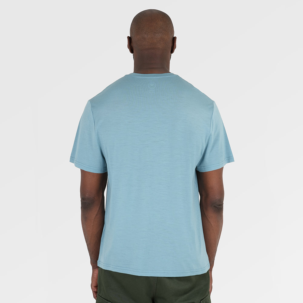 Mens Merino 150 Emblem Relaxed Tee (Lagoon/Navy) | Model: Michael