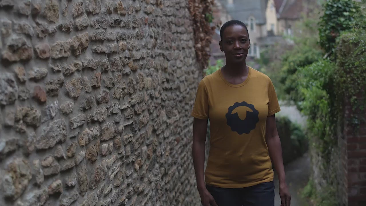 Isobaa | Womens Merino 150 Emblem Tee (Mustard/Navy) | Conquer trails and city streets in comfort with Isobaa's superfine Merino T-Shirt. | align: 55% 50% | Model: Yolisa