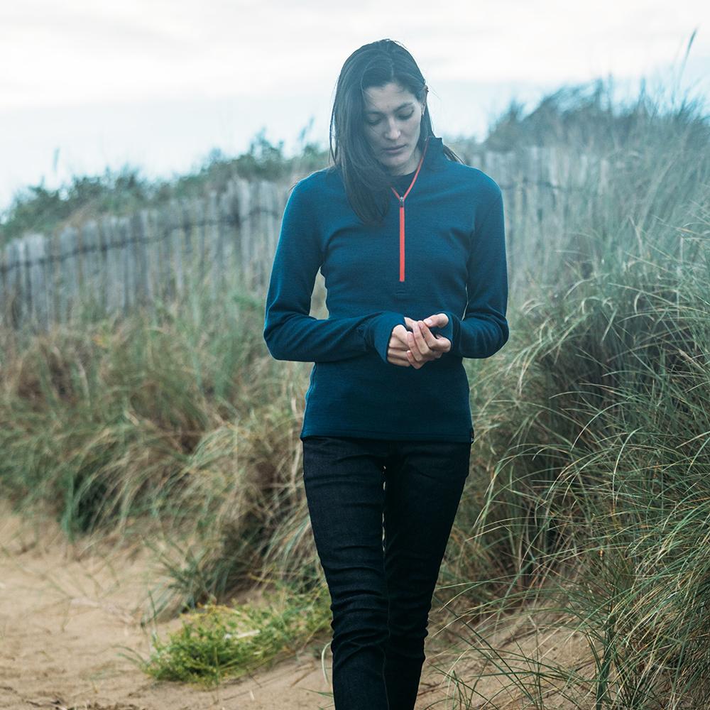 Isobaa | Womens Merino 320 Long Sleeve Half Zip (Petrol/Orange) | Conquer cold trails, blustery commutes, and unpredictable weather with the ultimate Merino wool half-zip top. | Model: Jessica